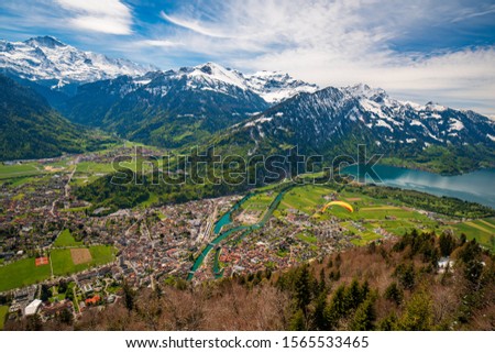 Breathtaking aerial view over Interlaken, Lake Thun and Swiss Alps from Harder Kulm view point. Interlaken - popular travel destination in Swiss Alps, Berner Oberland, Switzerland