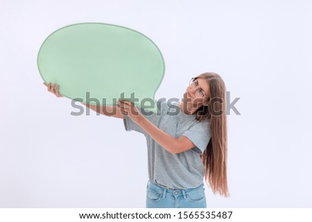casual girl looking at the speech bubble in her hands.