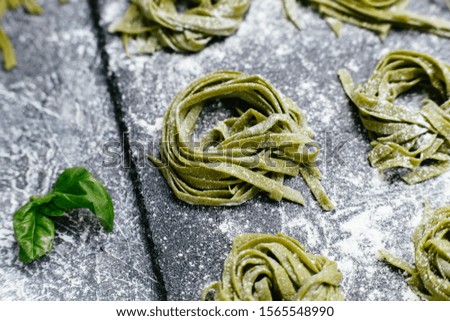 Spinach green pasta on a black slate plate