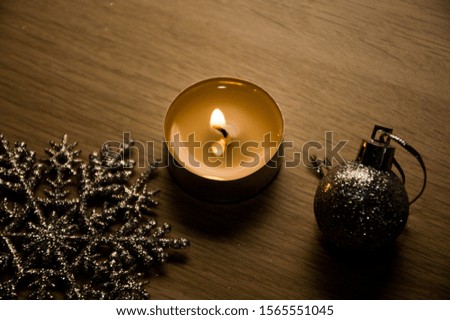 christmas still life with candle and decorations