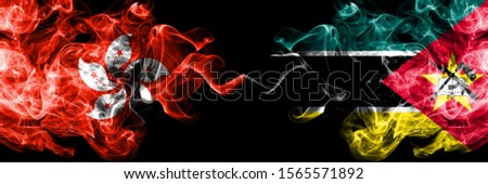 Hong Kong, China vs Mozambique, Mozambican smoky mystic states flags placed side by side. Concept and idea thick colored silky abstract smoke flags