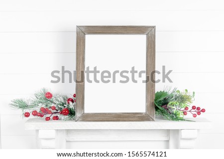 Vertical wooden frame mockup - empty frame on a light background with branches of greenery