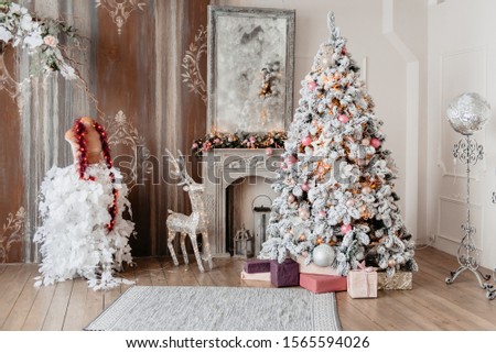 Beautiful holiday decorated room with a Christmas tree with gift