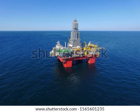 Offshore ultra-deepwater semi-submersible drilling rig in the middle of the ocean Royalty-Free Stock Photo #1565601235