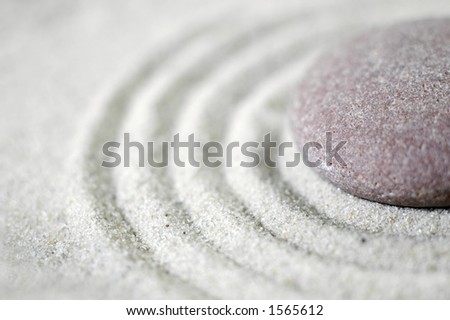 Raked sand around a pebble in a small tabletop rock garden (shallow DOF) Royalty-Free Stock Photo #1565612
