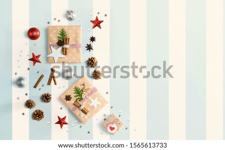 Handmade Christmas gift boxes with ornaments - flat lay