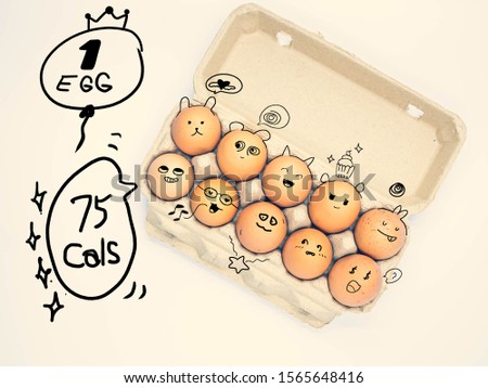 Directly above of cross processed tone  chicken brown eggs in paper box with hand drawing variety face feeling and text about egg calories doodle art for healthy eating, dieting and nutrition concept.