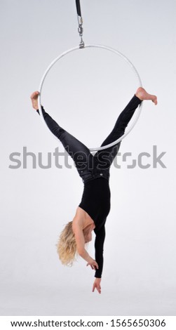 Slim and flexible Girl In An aerial hoop isolated On A White Background