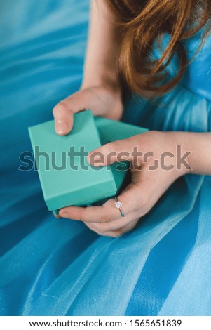 Girl holding a box with a gift for the New Year