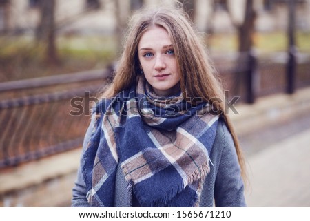 Pretty young woman outdoors. November portrait
