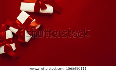 Christmas card with gifts on a red background. with a place for congratulations.