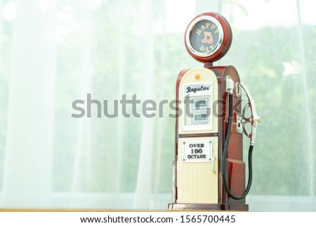 3d rendering of a bright red fuel pump in side view on white background with a large nozzle attached to it white pointing upwards. New market possibilities. Oil and gas industry. Cheapest refuel.