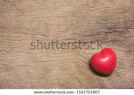 Red heart : red ball foam with shape heart for valentines card. Stress reliever foam ball isolated on wood plank background with copy space
