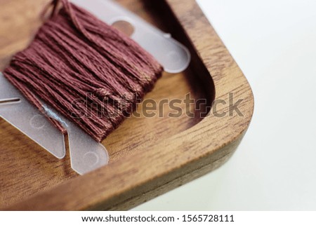 brown yarn spools on a wooden container
