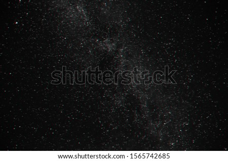 stars in the night dark blue sky with the milky way. Black and white photo with 3D glitch effect