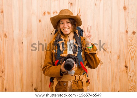 young pretty traveler woman with a photo camera