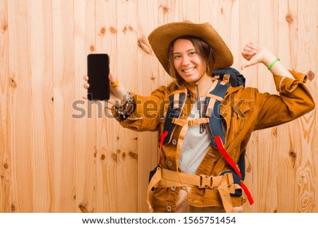 young pretty traveler woman with a mobile phone