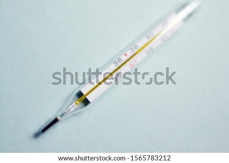 Mercury thermometer. Heat. Illness, flu, colds. Cold season. Glass thermometer. Degrees Celsius.