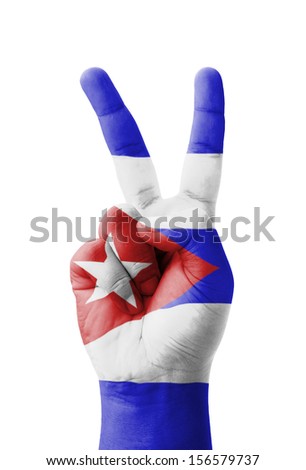 Hand making the V sign, Cuba flag painted as symbol of victory, win, success - isolated on white background