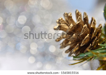 pine cones with goldes shining and green sparkling shapes forming together a christmas garland