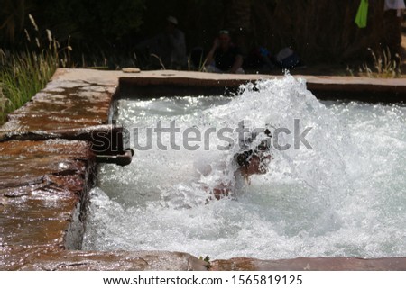 Fast flowing water at an oasis with fast shutter speed shows individual drops