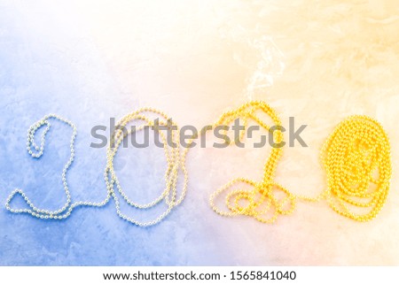 Christmas decoration. New year 2020 figures made of gold beads on cement background. Christmas concept with beads. Decorative design Christmas with New year 2020. Top view