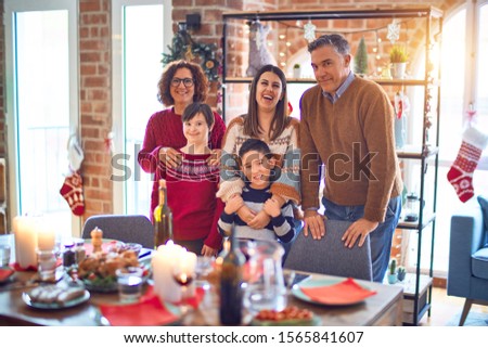 Beautiful family smiling happy and confident. Standing and posing celebrating christmas at home