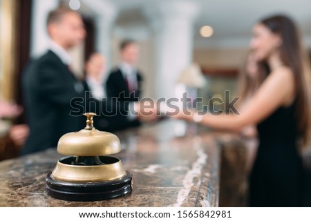 Picture of guests getting key card in hotel 