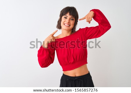 Young beautiful woman wearing red summer t-shirt standing over isolated white background smiling cheerful showing and pointing with fingers teeth and mouth. Dental health concept.