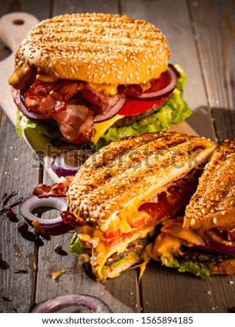 Bacon burger with beef patty on wooden table