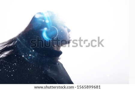 Portrait of beautiful woman with flowing hair in headphones listening music with closed eyes. Double exposure of female face and galaxy isolated on white background. Digital art.
