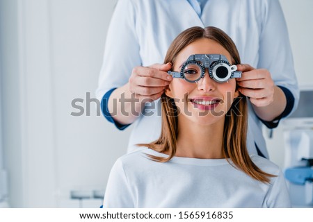Female patient checking vision in ophthalmological clinic Royalty-Free Stock Photo #1565916835