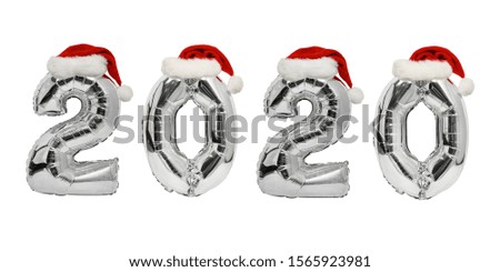 Number 2020 of silvery balloons with red Santa hats. White background. New Year concept