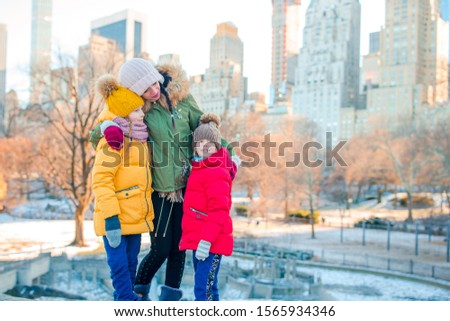 Family of mother and kids in Central Park during their vacation in NYC