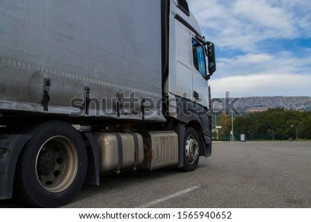 truck with a trailer parked in the background of mountains