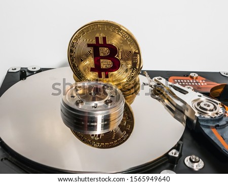 Bitcoin BTC on Open Hard Disk HDD Mixed media blockchain cryptocurrency top view business concept isolated on a white background.