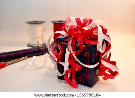Fancy wrapped gift with red and white ribbon and bows
