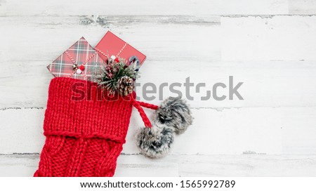 Closeup of chunky knit red Christmas stocking on white background with space for copy