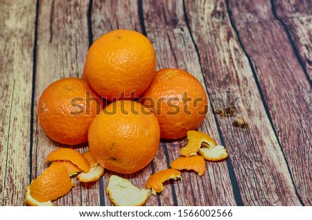 Ripe orange mandarins on the gray wooden background, top view, empty space