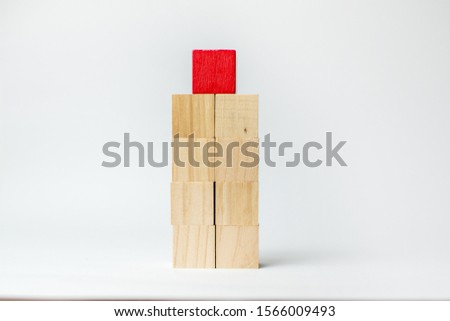 Red wood block stacking as step stair, With the concept of a thriving business going for success.