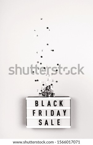Light board with text Black Friday Sale on grey background.