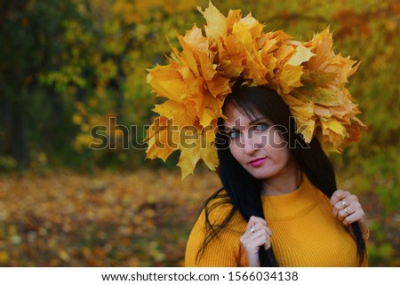 Beautiful brunette woman in the autumn park in the most amazing and colorful period of autumn. Autumn photo shoot. Toned