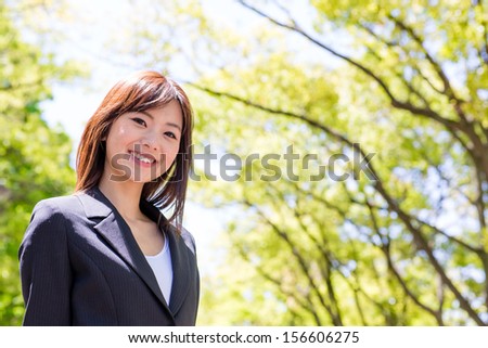 young asian businesswoman in the park