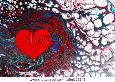 Big red heart lies on an abstract picture