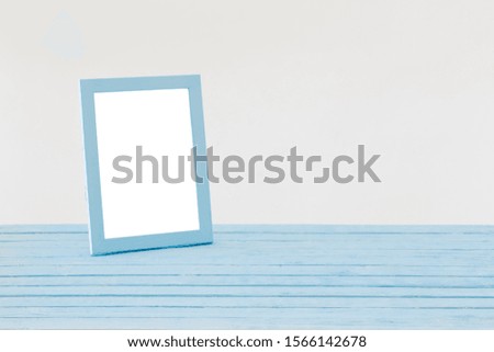 blue wooden frame on background white wall