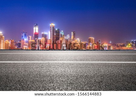 Empty asphalt road and urban architectural lights in Chongqing