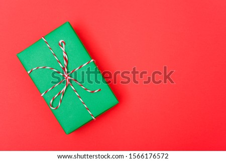 New Year, Christmas Xmas holiday composition, Top view green gift box on red background with copy space