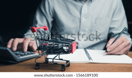Businessman doing accounting on shopping online