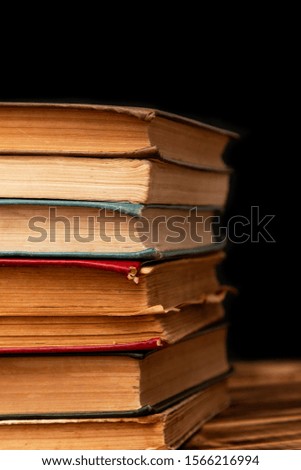 stack of old books on a black background