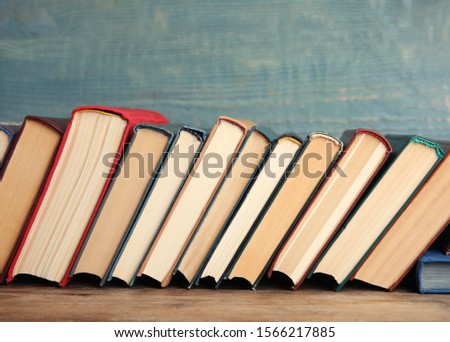 Collection of old books on wooden shelf